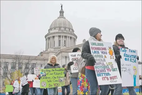  ?? Sue Ogrocki Associated Press ?? TEACHERS picket at the state Capitol in Oklahoma City. They are calling on lawmakers to approve $10,000 in raises across three years.