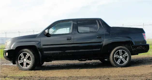  ?? Justin Mastine- Frost/ Edmonton Journal ?? Bridging the gap between the SUV and truck markets, the 2013 Honda Ridgeline Sport benefits from design tweaks that have toughened its exterior style.