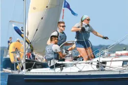  ?? WILLY KEYWORTH/SPINSHEET MAGAZINE ?? Helmsman Nick Gibbons keeps an eye on the course while spinnaker trimmer Sydney Richardson and mainsail trimmer Koby Nguyen work to optimize the sails aboard the Navy 44 Gallant during the Annapolis Labor Day Regatta. Gallant, skippered by Renee Bonner, was the runner-up in PHRF A.