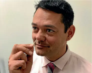  ?? AP ?? University of California, Irvine School of Medicine researcher Raheeb Saavedra demonstrat­es how to use a medicated nose swab to prevent superbug infections.
