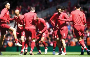  ?? — AFP Photo ?? Liverpool’s midfielder Mohamed Salah (second right) warms up with team mates for the English Premier League match against Wolverhamp­ton Wanderers at Anfield in Liverpool, north west England in this May 12 file photo.