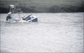  ?? ANNIE RICE — CORPUS CHRISTI CALLER-TIMES VIA AP ?? A boat sinks in the Packery Channel during Hurricane Hanna, Saturday, July 25, 2020, in North Padre Island, Texas.