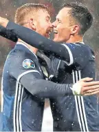  ??  ?? Stuart Findlay embraces fellow debutant Lawrence Shankland.