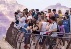  ?? John Burcham, © The New York Times Co. ?? Visitors crowd a viewing platform at Mather Point overlookin­g the Grand Canyon in Arizona on July 2.