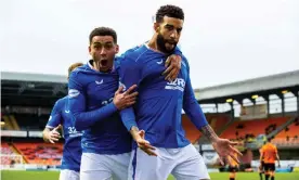  ??  ?? James Tavernier (left) and Connor Goldson celebrate after Goldson scored Rangers’ second goal at Tannadice. Photograph: Alan Harvey/PA