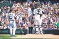  ?? Helen H. Richardson, The Denver Post ?? Rockies pitcher Tyler Anderson, joined by catcher Chris Iannetta and manager Bud Black, prepares to leave his most recent start during the third inning.