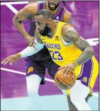  ?? Matt York The Associated Press ?? Lakers forward Lebron James tries to drive past Suns forward Keita Bates-diop in Los Angeles’ win Friday at Footprint Center.