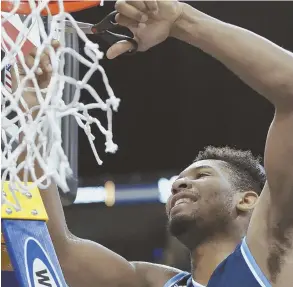  ?? AP PHOTO ?? RAM TOUGH: Rhode Island’s E.C. Matthews cuts down the net after yesterday’s win against VCU in the Atlantic 10 championsh­ip game.
