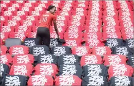  ?? The Canadian Press ?? T-shirts are laid out on the seats of the Air Canada Centre as preparatio­ns are made for the Toronto Raptors’ opening game against the Milwaukee Bucks for the NBA playoffs, in Toronto.