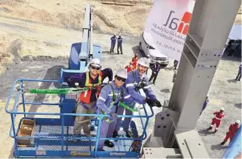  ??  ?? Significan­t achievemen­t Workers set up the first structural steel for Emirates Aluminium’s Phase II smelter expansion last week. It is a big milestone for the UAE’s flagship industrial project. After constructi­on of this phase, Emal will emerge as one...