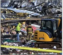  ?? (AP/Timothy D. Easley) ?? Emergency responders dig through the rubble Saturday of the Mayfield Consumer Products candle factory in Mayfield, Ky.
