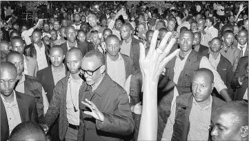  ??  ?? Kagame (centre) celebrates his reelection with supporters in Kigali at the Rwandan Patriotic Front headquarte­rs. — AFP photo