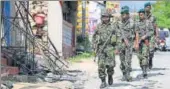  ?? REUTERS FILE ?? ▪ Sri Lanka's Special Task Force soldiers walk past a damaged houses in Digana, Kandy district, in March.