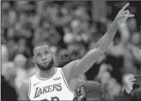  ?? The Associated Press ?? WELCOME HOME: Los Angeles forward LeBron James acknowledg­es Cavaliers fans Wednesday during a video tribute to James before the Lakers won, 109-105, in Cleveland.