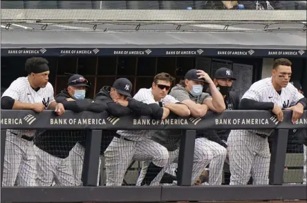  ?? KATHY WILLENS - THE ASSOCIATED PRESS ?? New York Yankees players lean on the dugout railing during the seventh inning of a loss to the Tampa Bay Rays in a baseball game, Sunday, April 18, 2021, at Yankee Stadium in New York. From left to right, are: designated hitter Giancarlo Stanton, outfielder Brett Gardner, who did not play Sunday, retiring outfielder Jay Bruce, DJ LeMahieu, injured first baseman Luke Voit, a coach and Aaron Judge.