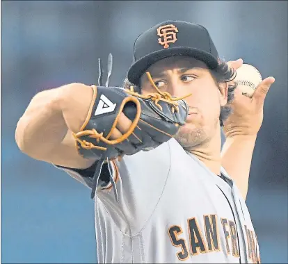  ?? MARK J. TERRILL — ASSOCIATED PRESS ?? Giants starter Derek Holland allowed six hits and walked four in 4 2⁄3 innings, but none of those runners came around to score.