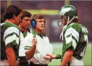  ?? ASSOCIATED PRESS FILE PHOTO ?? Philadelph­ia Eagles head coach Dick Vermeil, center, talks to quarterbac­k Ron Jaworski with assistant coach Ken Inman and Joe Pisarcik on the sidelines during a game in this 1981 photo.