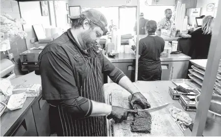  ?? Photos by Elizabeth Conley / Staff photograph­er ?? Brett’s BBQ Shop pitmaster and owner Brett Jackson has lived in Katy since grade school and says the city is in an “excitement period” as its diverse cuisine expands. With help from Jackson’s shop, Katy is now solidly part of the craft barbecue movement.