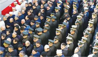  ?? (Osman Orsal/Reuters) ?? OFFICERS AND CIVILIANS attend the funeral in Istanbul on Sunday of Fehmi Barcin, a Turkish soldier killed in Saturday’s blast in the central Turkish city of Kayseri.