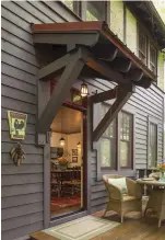  ??  ?? TOP RIGHT North Carolina pots fill out the shelves of a well-used, ca. 1940s bookcase in the master bedroom. RIGHT A heavily bracketed front entry with exposed rafter tails emphasizes the house’s Arts & Crafts era precedents.