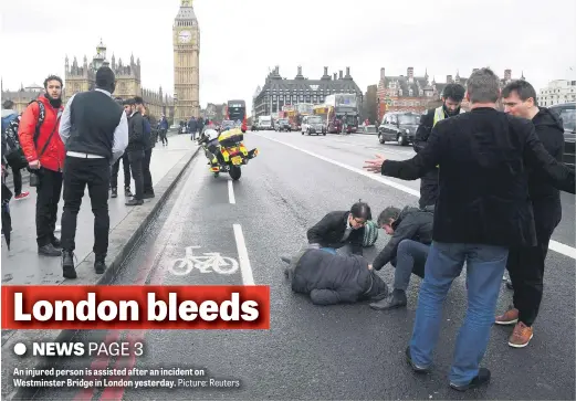  ?? Picture: Reuters ?? An injured person is assisted after an incident on Westminste­r Bridge in London yesterday.