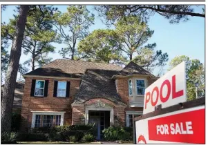  ?? (AP/Houston Chronicle/Melissa Phillip) ?? A real estate sign marks a home for sale recently in Houston.