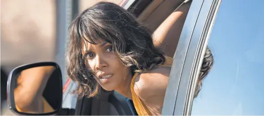  ?? PHOTOS BY PETER IOVINO, RELATIVITY MEDIA ?? Halle Berry’s Karla pulls some serious moves on the road: “Driving backward in highway traffic ... your heart leaves your body.”