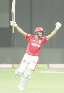  ??  ?? Chris Gayle and Manak Argawal celebrate their team’s double super over win in contrastin­g fashion. (Photo courtesy IPL website)