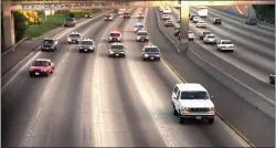  ?? JOSEPH VILLARIN — THE ASSOCIATED PRESS ?? On June 17, 1994, a white Ford Bronco, driven by Al Cowlings carrying O.J. Simpson, is trailed by Los Angeles police cars as it travels on a freeway in Los Angeles.