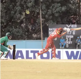  ?? CWI MEDIA ?? Windies batsman Roston Chase (right) plays a shot while players from the Bangladesh Cricket Board XI look on during their game at Savar, Bangladesh, yesterday.