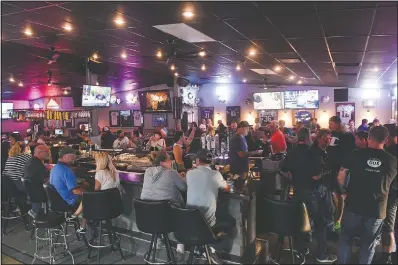  ?? (The Argus Leader/Erin Bormett) ?? Patrons fill the Crow Bar in Sioux Falls, S.D. on June 18. Authoritie­s are closing honky tonks, bars and other drinking establishm­ents in some parts of the U.S. to stem the surge of covid-19 infections — a move backed by sound science about risk factors that go beyond wearing or not wearing masks.