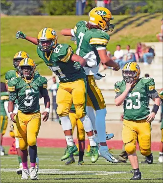  ?? SEAN D. ELLIOT/THE DAY ?? New London’s Ronde Ford (27) and Owen George (7) celebrate Ford’s intercepti­on during Saturday’s 13-8 victory over Fitch at Cannamela Field.