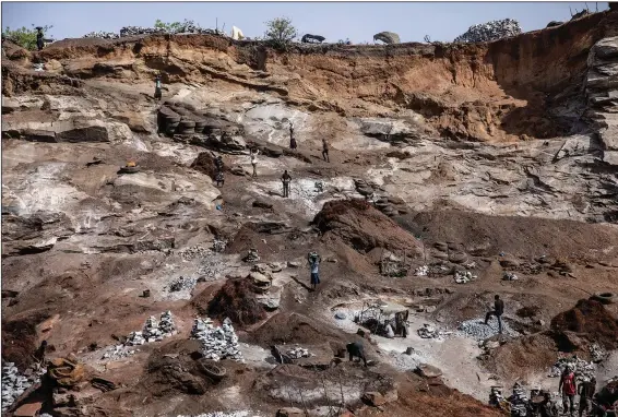  ?? (AP/Sophie Garcia) ?? People work April 27 in a granite mine on the outskirts of Ouagadougo­u, Burkina Faso.