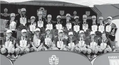  ?? VAL TEIXEIRA PHOTO ?? Premier Navy 2001 poses for a team photo after winning the girls under-18 title game at the United States Youth Soccer National Championsh­ips on July 28 in Overland Park, Kansas.