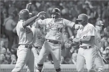  ?? MATT SLOCUM — ASSOCIATED PRESS ?? The Dodgers’ Enrique Hernandez (14) celebrates after hitting a grand slam during the third inning of Game 5of the NLDS. Hernandez homered three times and drove in seven runs as L.A. clinched a spot in the World Series.