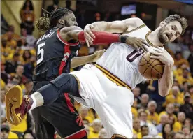  ?? TONY DEJAK / ASSOCIATED PRESS ?? The Raptors’ DeMarre Carroll (left) and the Cavaliers’ Kevin Love tangle in Game 1. Love was the Cavs’ third-leading scorer with 18 points.