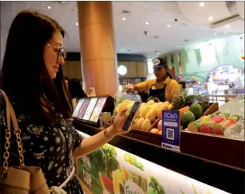  ?? PROVIDED TO CHINA DAILY ?? A customer tries electronic payment in a supermarke­t in Manila, the Philippine­s.