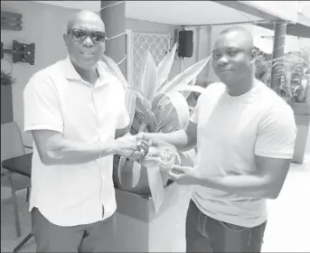  ?? ?? One-Star Referee Lawrence Assanah (right) receiving his accreditat­ion insignia from GBA President Steve Ninvalle