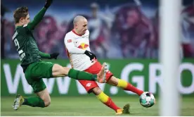  ?? Photograph: Annegret Hilse/AFP/Getty Images ?? Angeliño, preparing to shoot against Augsburg last month, is RB Leipzig’s second highest scorer this season despite playing at full-back.