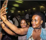  ??  ?? Rwandan ladies taking selfies during the party