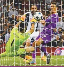  ??  ?? Cristiano Ronaldo (right) shoots over Juventus goalkeeper Gianluigi Buffon to score Real Madrid’s third goal during yesterday’s Champions League final at The Principali­ty Stadium in Cardiff. –