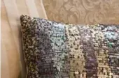  ?? DREAMSTIME ?? Gold, silver and rose metallic sequins line up nicely on a throw cushion.