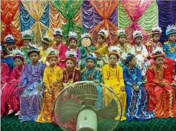  ??  ?? Vibrant heritage: Children dressed in traditiona­l attire waiting to begin a ceremonial parade in