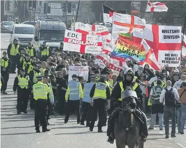 ??  ?? Police lead the EDL march from London Road into the city centre
