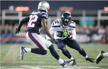  ?? — GETTY IMAGES FILES ?? Christine Michael, right, of the Seattle Seahawks carries the ball against the New England Patriots last Sunday in Foxboro, Mass.