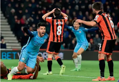  ?? — AFP ?? Manchester City’s Sergio Aguero (left) celebrates after his team’s second goal against Bournemout­h.