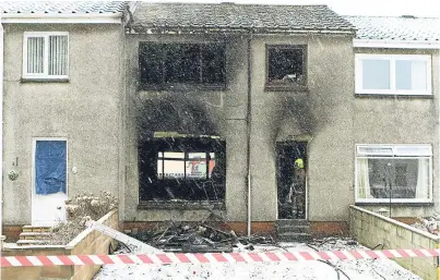  ?? Picture: Dougie Nicolson. ?? The scene in Melfort Place, Trottick, after the fire which wrecked a house.