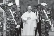  ?? ANDREW MEDICHINI/AP PHOTO ?? Pope Francis reviews an honor guard Thursday as he arrives at Dhaka’s internatio­nal airport in Bangladesh.