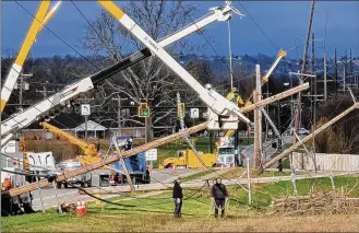  ?? NICK GRAHAM / STAFF ?? High winds, estimated at close to 50 mph, blew through parts of Butler County late Thursday and into Friday, knocking down large poles such as these on Princeton Road in Fairfield Twp.