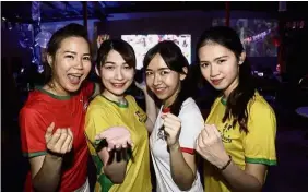  ??  ?? Knockouts: (From left) Administra­tion clerk Zoey Oon, 24, posing for a group photograph with her friends – Eve Loh, 24, Juliet Tang, 23, and Juliana Lee, 22 – before watching a World Cup game in George Town.